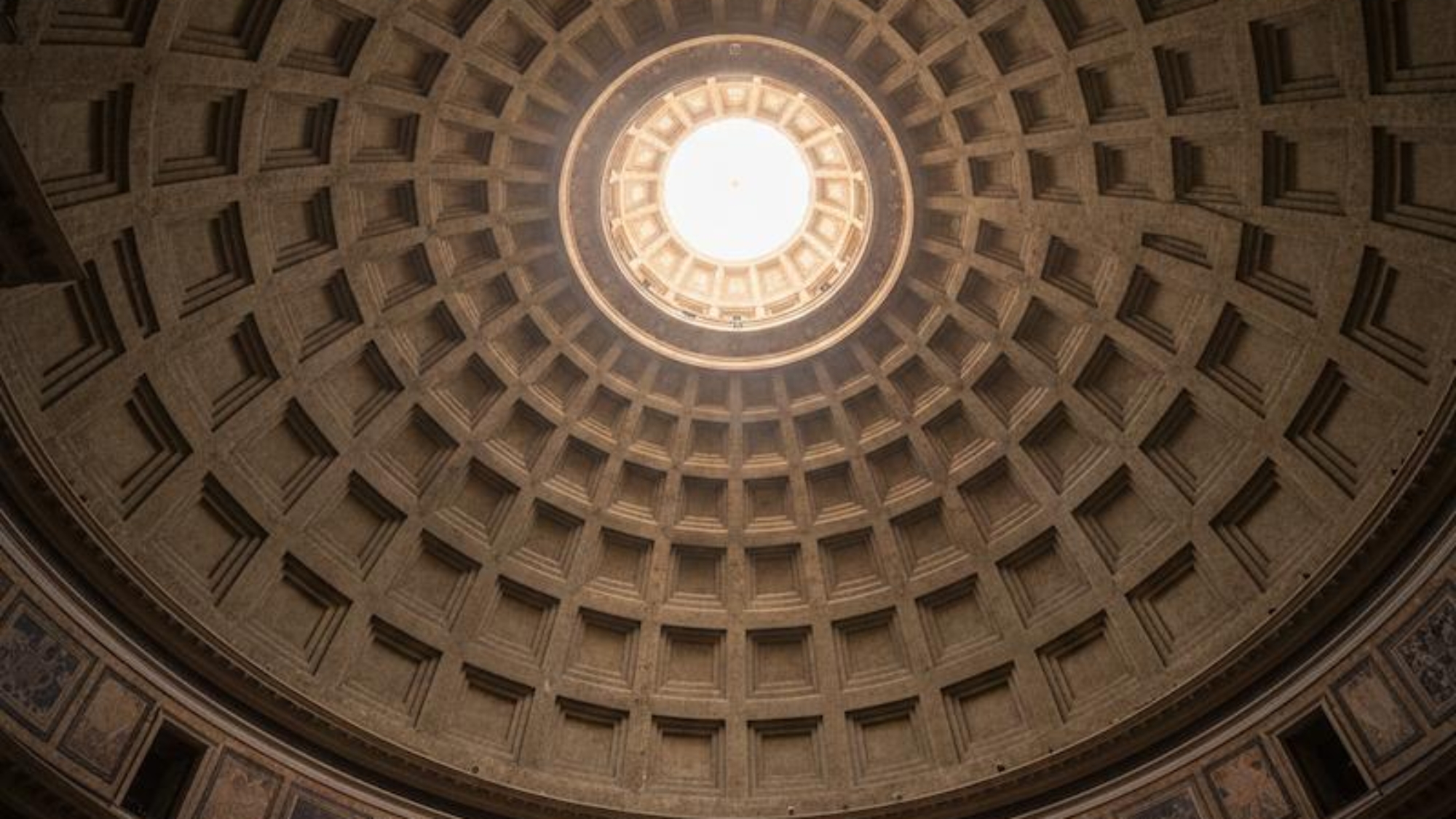 Interior view of the Pantheon dome in Rome with natural light streaming through the central oculus.
