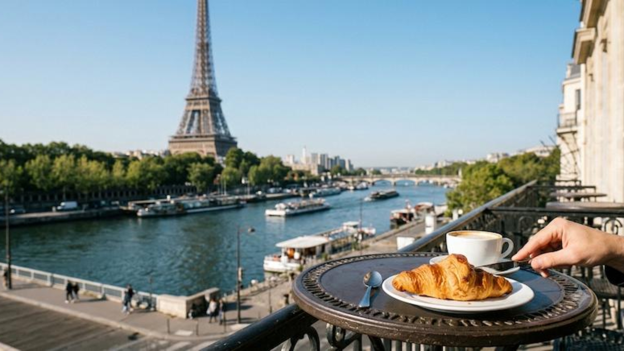 enjoying a croissant in paris with eiffel tower view
